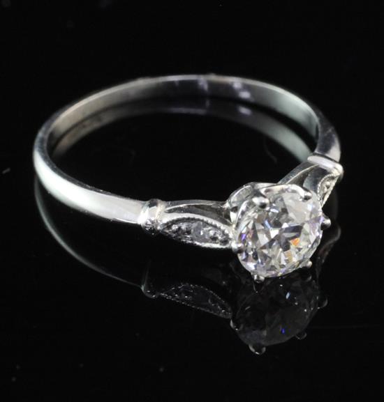 A platinum and single stone diamond ring with diamond set shoulders, size L.